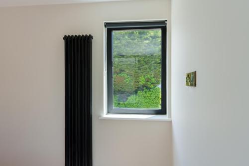 one-off-house-new-build-black-radiator-cortizo-cor80-arch-invisible-window-stone-builders-killiney-dublin-60