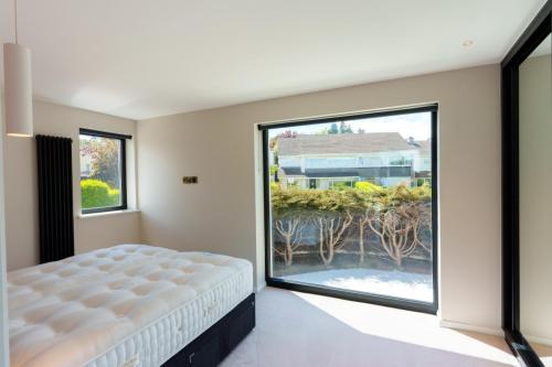 one-off-house-new-build-main-bedroom-with-large-window-stone-builders-killiney-dublin-57